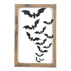 a wooden frame with bats cut out of it