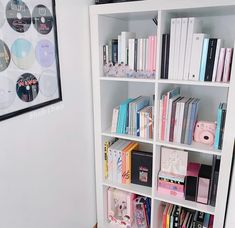 a white book shelf filled with lots of books