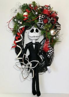 a wreath with a skeleton and christmas decorations