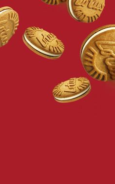 some gold coins are falling down on a red background and there is no image here to provide a caption for