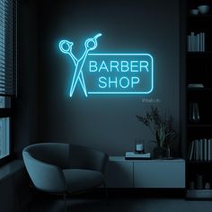 a neon sign that says barber shop in front of a room with a chair and window