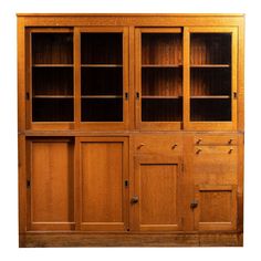 a wooden bookcase with glass doors and drawers