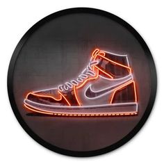 a pair of sneakers with neon lights in the shape of a shoe on a black circle