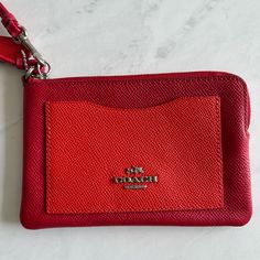 ** Color: Red (Front Pocket Has A Lighter Tone) ** Two Credit Card Slots On The Inside ** Zip-Top Closure ** Silver Details ** Perfect Size For Cards And Cash ** Never Used, Like New Red Coach Wristlet With Zipper Closure, Coach Red Wristlet With Zipper Pouch, Coach Red Wristlet With Zipper Closure, Red Coach Wristlet For Everyday Use, Elegant Red Wristlet With Zipper Pouch, Red Coach Rectangular Wristlet, Red Coach Wristlet For Daily Use, Red Zipper Pouch Wristlet, Red Clutch Wristlet With Removable Pouch