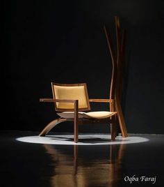 a wooden chair sitting on top of a black floor