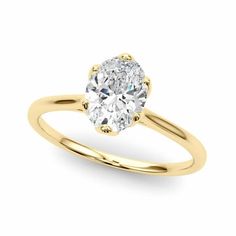 a yellow gold engagement ring with an oval cut diamond in the center, on a white background