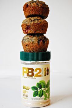 three muffins stacked on top of each other in front of a jar of pb2