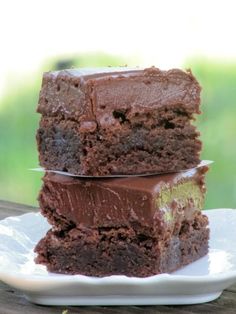 three pieces of chocolate cake stacked on top of each other