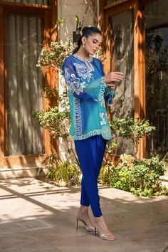 A blue ombre organza shirt is delicately rendered with bold ivory embroidery in a floral and fruit imagery. Featuring a keyhole neckline and scalloped sleeves, the shirt is paired with a royal blue rawsilk shalwar. Model Height is 5'9 and Shirt length is 32" Ivory Embroidery, Scalloped Sleeves, Organza Shirt, Designer Name, Keyhole Neckline, Eid Collection, Blue Ombre, How To Dye Fabric, Blue Suit