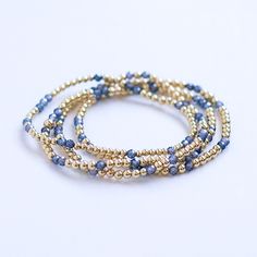 THIS LISTING IS FOR A SINGLE BRACELET.   Deep blue Zircon beads are set in a random pattern with your choice of 14K Gold Filled or genuine 925 sterling silver beads to create a dainty piece perfect for stacking or layering.  They layer together for a trendy casual look or pair one with others pieces for a fun stack.  Bracelets measure 6.25" and stretch to fit most wrist sizes. Suggested to wear with: https://perlinebyamymegan.etsy.com/listing/1746333166 or https://perlinebyamymegan.etsy.com/list Blue Stackable Jewelry With Round Beads, Blue Bracelets With Gold Beads For Jewelry Making, Everyday Blue Bracelets With Gold Beads, Blue Jewelry With Gold Beads, Sterling Silver Stacking Bracelets, Layering Bracelets, Stack Bracelets, Single Bracelet, Stacking Bracelets