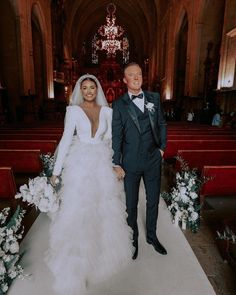 a bride and groom are standing in front of the alter