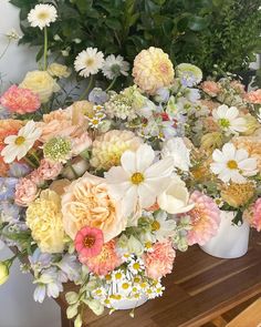 a bunch of flowers that are sitting on a table