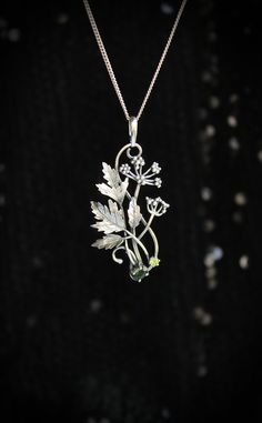 ITEM DESCRIPTION: The size H 5 cm x W 3 cm (2 x 1 1/3 inch). Weight - 5 g. You can buy it with a silver chain or without it. Even simple plants look very elegant. I made one of sterling silver, pretty green tourmaline, and peridot. This unique botanical jewelry looks like a real treasure of wild forest. It is really worthy of being in your precious collection. Expect many compliments on this! This handmade necklace will come to you in a gift box - ready for gifting. The parcel will be sent durin Nature-inspired Engraved Flower Pendant Necklace, Delicate Green Sterling Silver Necklaces, Delicate Green Sterling Silver Necklace, Green Sterling Silver Flower Pendant Jewelry, Botanical Sterling Silver Jewelry Gift, Silver Engraved Nature-inspired Necklace, Green Sterling Silver Necklace With Flower Pendant, Nature-inspired Silver Metal Necklace, Nature-inspired Sterling Silver Leaf Necklace