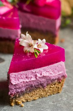 a piece of cake with pink frosting and flowers on top