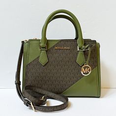 New With Tag Michael Kors Hope Medium Messenger Crossbody Bag Small Satchel Pvc Leather Mk Signature Brown Green (Evergreen Multi) 100% Authentic Retail:$368.00 Plus Tax ***Please See The Measurement For The Size*** No Dust Bag Gold Toned Hardware Michael Kors Logo At Front Zip Top Closure Back & Front Snap Pockets Custom Fabric Lining Center Zip Pocket 1 Zipper Pocket 1 Slip-In Pockets 10.5" (L) X 8"(H) X 4.75"(D) Strap: 3.25", 20"-24" Very Clean, Smoke-Free And Pet-Free Environment. Green Logo Crossbody Shoulder Bag, Green Crossbody Bag With Logo, Green Logo Crossbody Bag, Green Top Handle Bag With Logo, Designer Green Crossbody Satchel, Green Top Handle Shoulder Bag With Logo, Designer Green Bags With Branded Hardware, Green Shoulder Bag With Logo, Green Logo Shoulder Bag