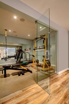 a gym with mirrors and equipment on the floor in front of it's walls