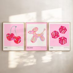 three pink posters with hearts and dices on them, hanging up against a wall