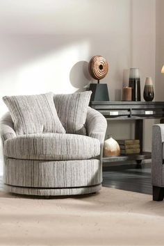 a living room with two chairs and a round chair in the middle of the room