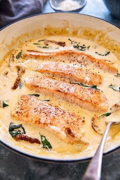 some fish is being cooked in a white sauce