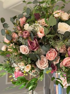 a vase filled with lots of flowers on top of a table