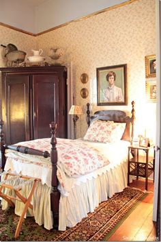 a bedroom with a bed, dresser and pictures on the wall above it's headboard