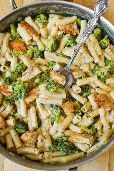 broccoli and chicken pasta in a bowl with a spoon