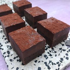 four pieces of chocolate cake sitting on top of a table