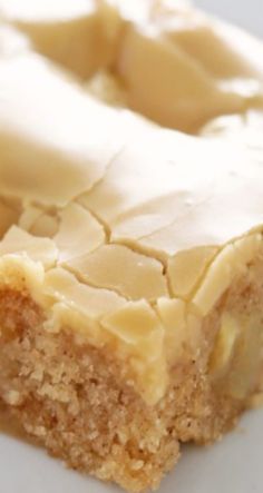 a piece of cake sitting on top of a white plate covered in frosted icing