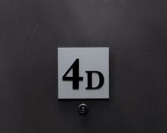 a sign that says 4d on it in black and white with the number four