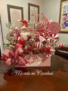 a christmas centerpiece with candy canes and santa clause