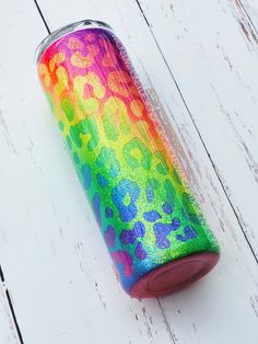 a colorful can sitting on top of a white wooden floor