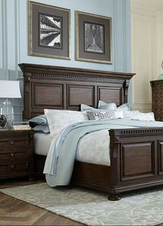 a bedroom with blue walls and wooden furniture