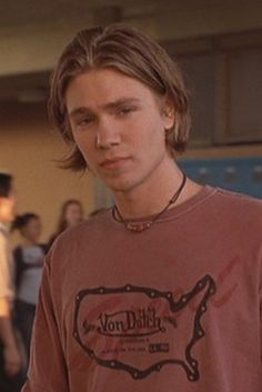 a young man standing in front of a group of people