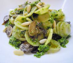 pasta with mushrooms and broccoli on a white plate