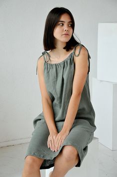 "Moss green softened linen dress with regulating straps. Dress with pockets. THE DRESS IS 35.4\" / 90 cm long. Choose size: XS Bust 82 - 84 cm. ( 32 1/4\" - 33\") Waist 66 - 68 cm. / (26\" - 26 3/4\") Hips 90 - 92 cm. / (35 1/2\" - 36 1/4\") S Bust 86 - 88 cm. ( 33 3/4\" - 34 3/4\") Waist 70 - 72 cm. / (27 3/4\" - 28 1/4\") Hips 94 - 96 cm. / (37\" - 37 3/4\") M Bust 90 - 92 cm. ( 35 1/2\" - 36 1/4\") Waist 74 - 76cm. / (29 1/4\" - 30\") Hips 98 - 100 cm. / (38 1/2\" - 39 1/4\") L Bust 94 - 96 c Sleeveless Linen Dress With Adjustable Straps, Linen Dress With Spaghetti Tie Straps, Spring Green Linen Sundress, Linen Dress With Adjustable Straps, Green Linen Sleeveless Sundress, Green Linen Summer Sundress, Linen Short Dress, Green Linen Dress, Interview Outfits