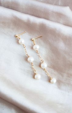 This listing is for a pair of freshwater pearl and 14k gold filled earrings. All gold accessories are 14k gold filled. The white freshwater pearls measure 6 mm. The earrings are 2 inches long. Perfect for everyday wear, weddings, gifts, and more! Please check out the matching freshwater pearl and 14k gold filled necklace here -https://wildcollections.etsy.com/listing/668016373  Please check out the matching freshwater pearl and 14k gold filled bracelet here -  https://wildcollections.etsy.com/listing/649806865 Earrings Gold Pearl, Earrings Pearl Drop, Weddings Gifts, Pearl Drop Earrings Gold, Drop Earrings Gold, Genuine Leather Bracelet, Earrings Bridesmaid, Etsy Bridesmaid Gifts, Gold Pearl Earrings