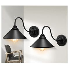 two black wall lights with one light on each side and the other off to the side