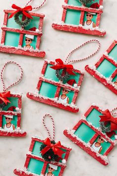 christmas ornaments made out of frames with red bows