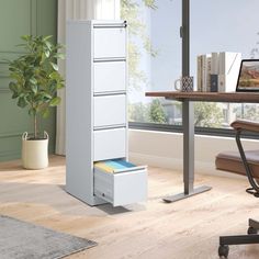 a white filing cabinet sitting in front of a window