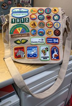 a bag with patches on it sitting on top of a counter