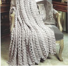 a crocheted blanket sitting on top of a chair