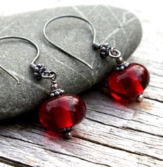 I have a passion for glass in all it's forms and work both with lampwork, fused and blown glass. These dangle glass bead earrings are part of my lampwork jewelry made in my little lampworking studio in the forest of Sweden. The glass beads are made from lovely deep red transparent glass. The beads were carefully annealed in a proper annealing kiln to eliminate stress in the glass. The findings are all sterling silver which were oxidized, brushed and polished to give a rustic feeling to the earri Glass Bead Earrings, Lampwork Jewelry, Bird Earrings, Holiday Earring, Oxidized Sterling Silver, Christmas Jewelry, Glass Earrings, Red Glass, Star Earrings