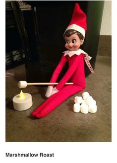 an elf is playing with marshmallows on the floor