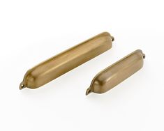 two brass handles on a white background