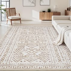 a living room with white couches and beige rugs in front of large windows