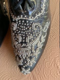 Here is an absolutely gorgeous pair of beaded black Victorian leather boots made by Marshall Fields & Co. Chicago. The toe box is adorned with rich, glittering glass beading that wraps around the sides. They show very little wear as if they were only worn once. As with most Victorian boots, they are quite small and very narrow: Toe to heel measure = 9 inches; ball of foot = 2 1/2 inches. It is certainly rare to find a pair of boots from this era in such magnificent shape. Elegant Evening Boots With Sequins, Elegant Sequined Boots For Evening, Elegant Leather Boots With Bling, Elegant Silver Sequined Boots, Designer Rhinestone Boots For Formal Events, Designer Rhinestone Boots For Formal Occasions, Designer Rhinestone Formal Boots, Elegant Bedazzled Evening Boots, Elegant Evening Bedazzled Boots