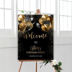 a welcome sign with gold balloons and confetti