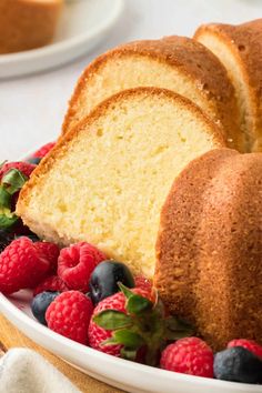 slices of pound cake on a plate with berries and raspberries