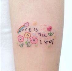 a tattoo that says love is all i got with flowers and an umbrella on it