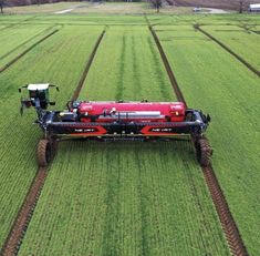 an aerial view of a farm tractor in the middle of a field